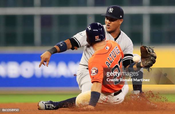 Jose Altuve of the Houston Astros steals second against Starlin Castro of the New York Yankees in the fourth inning during game one of the American...