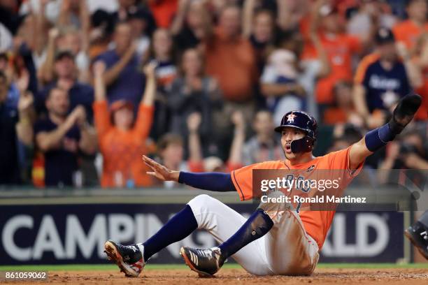 Carlos Correa of the Houston Astros scores on a single by Yuli Gurriel in the fourth inning during game one of the American League Championship...