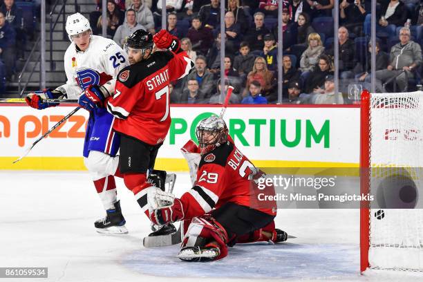 Goaltender Mackenzie Blackwood of the Binghamton Devils allows a goal in the second period while teammate Brian Strait defends against Michael...