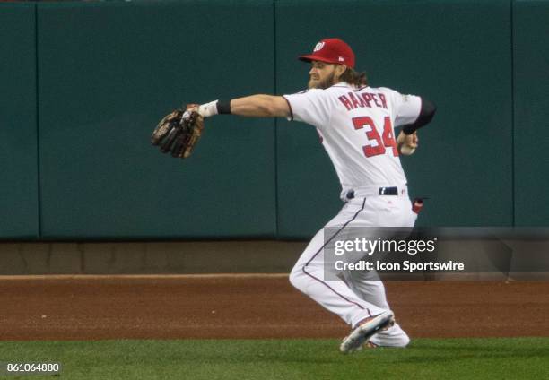 Washington Nationals right fielder Bryce Harper throws to home plate during game five of the NLDS between the Washington Nationals and the Chicago...