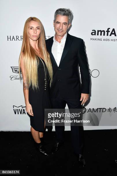 Actor Dermot Mulroney and Tharita Cesaroni attend the amfAR Gala at Ron Burkle's Green Acres Estate on October 13, 2017 in Beverly Hills, California.