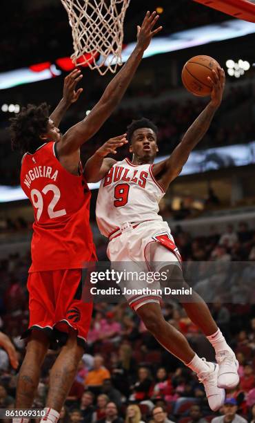 Antonio Blakeney of the Chicago Bulls puts up a shot against Lucas Nogueira of the Toronto Raptors during a preseason game at the United Center on...