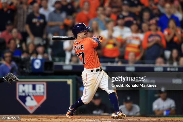 Jose Altuve of the Houston Astros hits a single in the eighth inning against the New York Yankees during game one of the American League Championship...