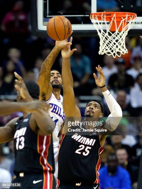 James Michael McAdoo of the Philadelphia 76ers battles Jordan Mickey of the Miami Heat for a rebound during the game at Sprint Center on October 13,...