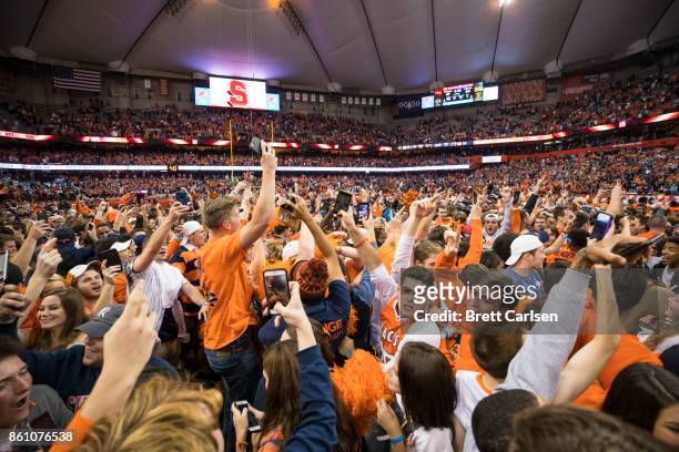 Syracuse Orange fans storm the field after the team upset Clemson Tigers at the Carrier Dome on October 13, 2017 in Syracuse, New York. Syracuse...