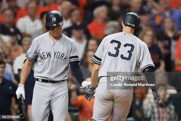 Greg Bird celebrates his solo homerun with Jacoby Ellsbury of the New York Yankees in the ninth inning against the Houston Astros during game one of...