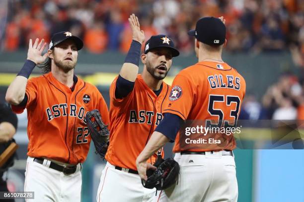 Ken Giles of the Houston Astros celebrates their 2 to 1 win over the New York Yankees with Marwin Gonzalez and Josh Reddick during game one of the...