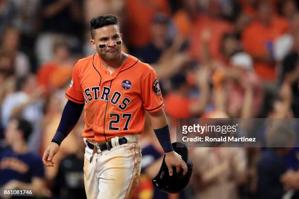 Jose Altuve of the Houston Astros celebrates after sliding into home to score on a single by Carlos Correa in the fourth inning against the New York...