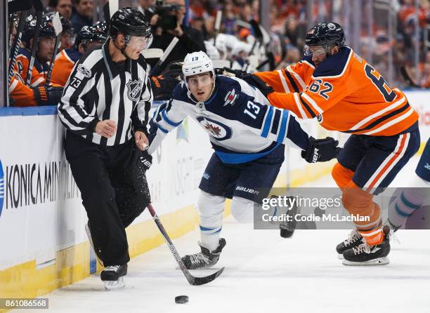 Eric Gryba of the Edmonton Oilers shoves Brandon Tanev of the Winnipeg Jets at Rogers Place on October 9, 2017 in Edmonton, Canada.