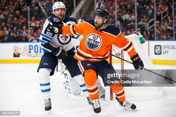 Eric Gryba of the Edmonton Oilers battles against Blake Wheeler of the Winnipeg Jets at Rogers Place on October 9, 2017 in Edmonton, Canada.