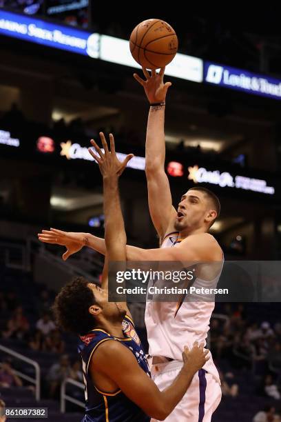 Alex Len of the Phoenix Suns attempts a shot over Grant Jerrett of the Brisbane Bullets during the second half of the NBA preseason game at Talking...