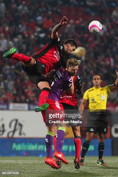 Alejandro Donatti L) of Tijuana and Cristian Menéndez of Veracruz jump for the ball during the 13th round match between Tijuana and Veracruz as part...