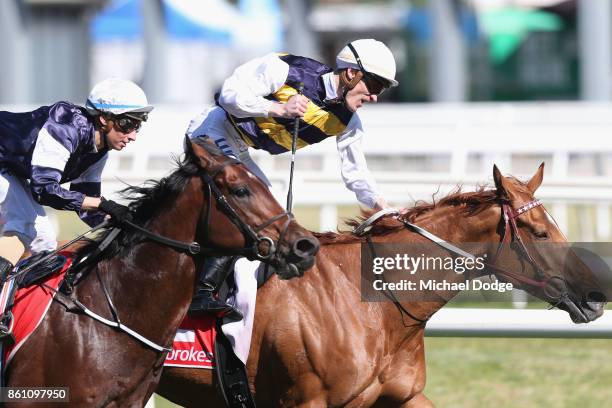 Jockey Mark Zahra celebrates winning on Gailo Chop from Katelyn Maylon on Johannes Vermeer during Melbourne Racing on Caulfield Guineas Day at...