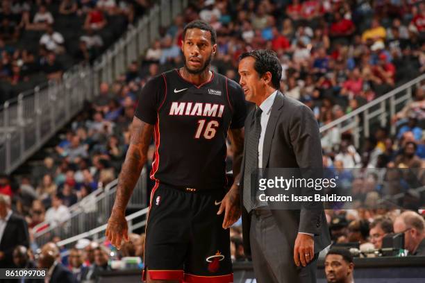 James Johnson of the Miami Heat speaks with Head coach Erik Spoelstra of the Miami Heat during the preseason game against the Philadelphia 76ers on...