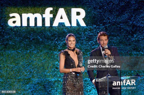 Heidi Klum and Alexander Gilkes speak onstage during the amfAR Gala Los Angeles 2017 at Ron Burkle's Green Acres Estate on October 13, 2017 in...