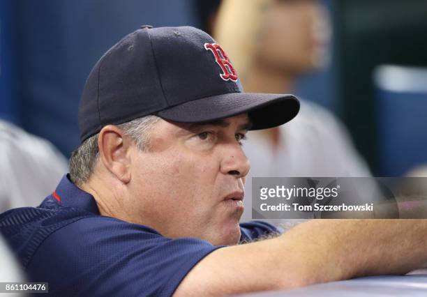 Manager John Farrell of the Boston Red Sox looks on from the top step of the dugout during MLB game action against the Toronto Blue Jays at Rogers...