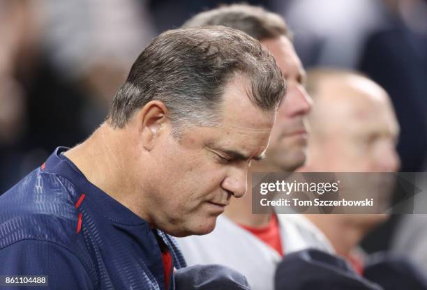 Manager John Farrell of the Boston Red Sox and bench coach Gary Disarcina and third base coach Brian Butterfield stand during the playing of the...