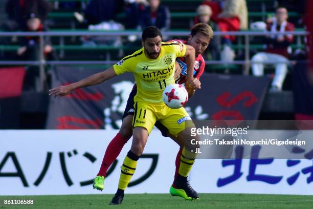 Diego Oliveira of Kashiwa Reysol and Akito Fukumori of Consadole Sapporo compete for the ball during the J.League J1 match between Consadole Sapporo...