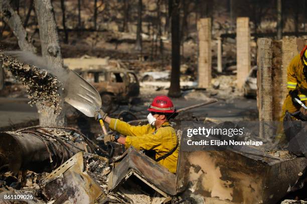 Firefighters search through the rubble of a home in the Fountaingrove neighborhood for a strongbox and a wedding ring on October 13, 2017 in Santa...