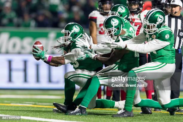 Trent Richardson of the Saskatchewan Roughriders and teammates celebrate after Richardson carried the ball for a first down in the game between the...