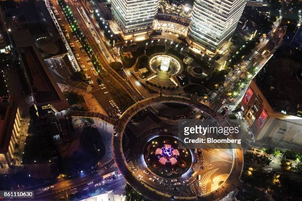 Pedestrian footbridge and vehicles travelling along roads are seen from the observation deck of the Oriental Pearl Tower at night in the Lujiazui...