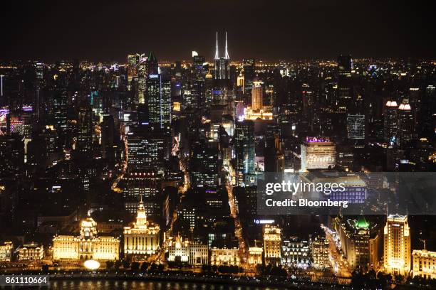 Illuminated commercial buildings are seen from the observation deck of the Oriental Pearl Tower at night in the Lujiazui Financial District in...