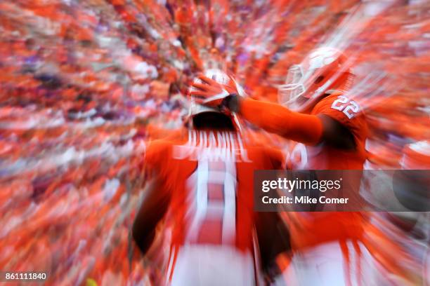 Defensive end Xavier Kelly slaps linebacker Dorian O'Daniel of the Clemson Tigers on the back of the helmet during the Tigers' game against the Wake...