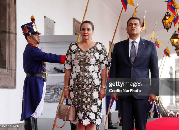 Honduras' President Juan Orlando Hernandez and first lady Ana Garcia, enter the Palace of Carondelet during a state visit, in Quito, Ecuador, October...