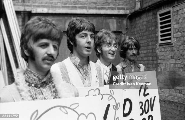 From left, Ringo Starr, Paul McCartney, John Lennon and George Harrison of English rock and pop group The Beatles pose together wearing sandwich...