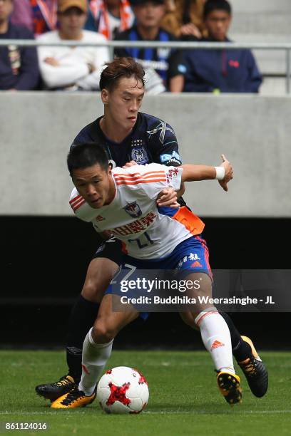 Yuto Horigome of Albirex Niigata and Oh Jae Suk of Gamba Osaka compete for the ball during the J.League J1 match between Gamba Osaka and Albirex...