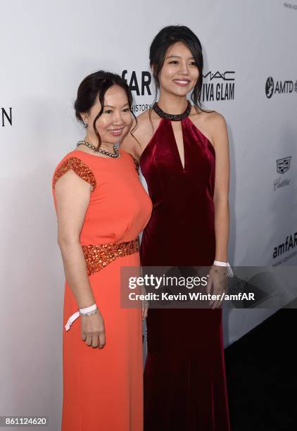 Fraye Zhou and guest attend the amfAR Gala Los Angeles 2017 at Ron Burkle's Green Acres Estate on October 13, 2017 in Beverly Hills, California.