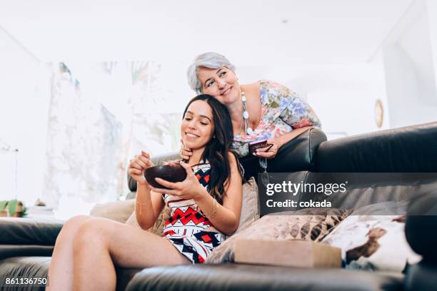 grandmother and granddaughter sharing a chocolate easter egg - sharing chocolate stock pictures, royalty-free photos & images