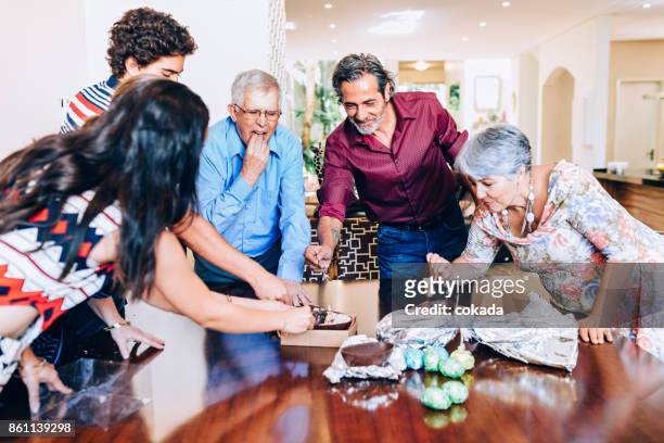 family eating a chocolate easter egg - sharing chocolate stock pictures, royalty-free photos & images