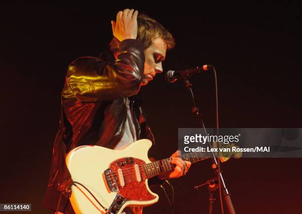 Photo of Damon ALBARN and BLUR; Damon Albarn performing live onstage, playing Fender Mustang guitar