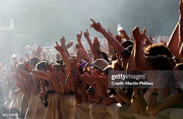 Photo of FESTIVALS; Fans in front row of crowd at summer festival, cheering, pointing