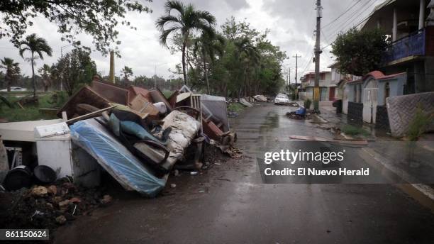Debris left over from Hurricane Maria as well as furniture, appliances and washed out vehicles, litter a street in Toa Baja Puerto Rico, on October...