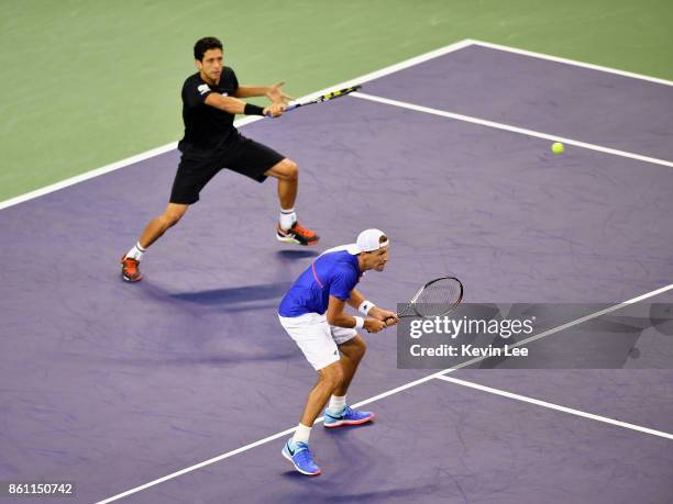 Marcelo Melo of Brazil and Lukasz Kubot of Poland and Jean-Julien Rojer of Netherland in action in the match between Marcelo Melo of Brazil and...