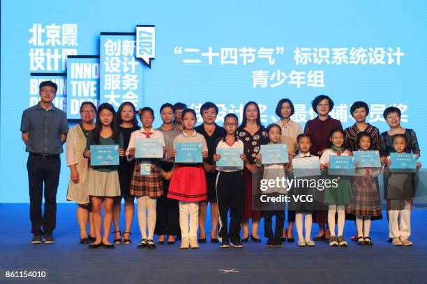 Winners who win "Logo Design Contest for the 24 Solar Terms" pose with their certificates at an award ceremony during 2017 Beijing Design Week on...