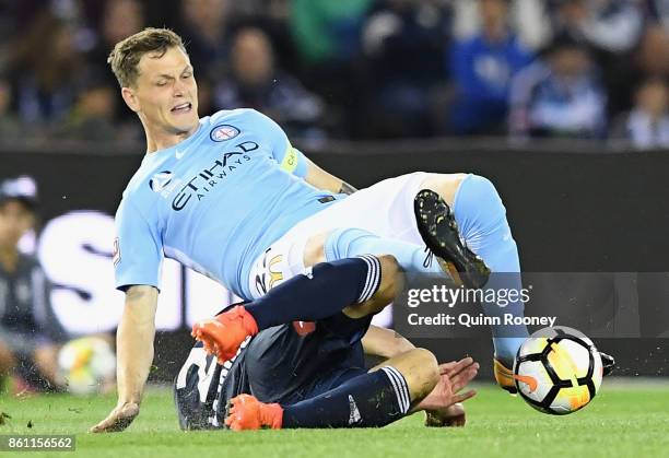 Michael Jakobsen of the City is tackled by Carl Valeri of the Victory during the round two A-League match between Melbourne Victory and Melbourne...