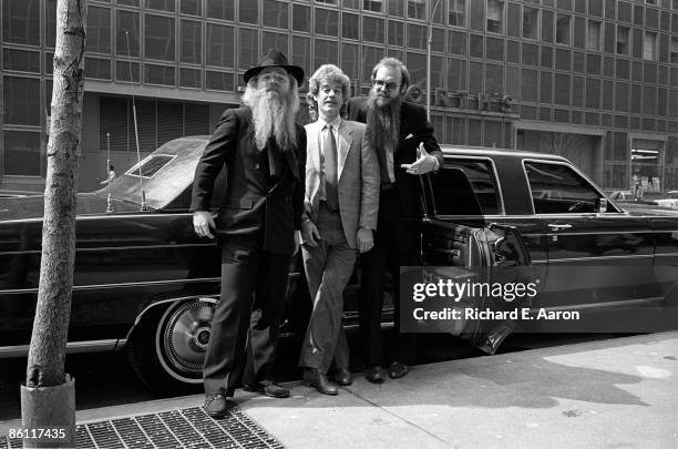 Photo of Frank BEARD and ZZ TOP and Dusty HILL and Billy GIBBONS; L-R. Dusty Hill, Frank Beard, Billy Gibbons - posed, group shot, by stretched...