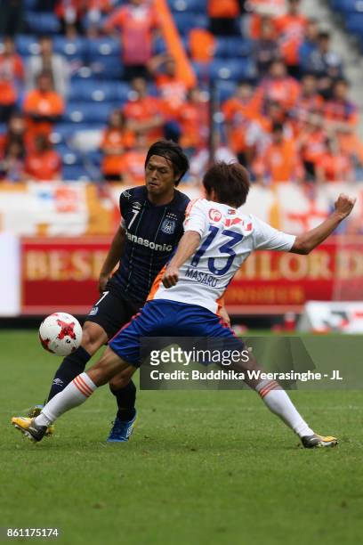 Yasuhito Endo of Gamba Osaka and Masaru Kato of Albirex Niigata compete for the ball during the J.League J1 match between Gamba Osaka and Albirex...