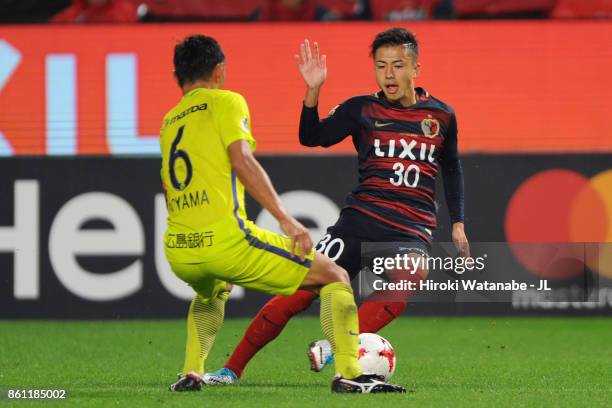 Hiroki Abe of Kashima Antlers and Toshihiro Aoyama of Sanfrecce Hiroshima compete for the ball during the J.League J1 match between Kashima Antlers...