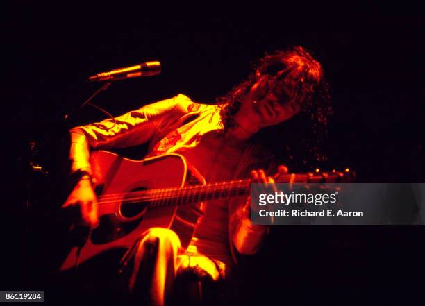 Photo of Jimmy PAGE and LED ZEPPELIN, Jimmy Page performing live onstage during the 1977 US tour , playing acoustic guitar