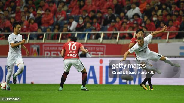 Lukas Podolski of Vissel Kobe reacts under pressure of Ryota Moriwaki of Urawa Red Diamonds during the J.League J1 match between Urawa Red Diamonds...