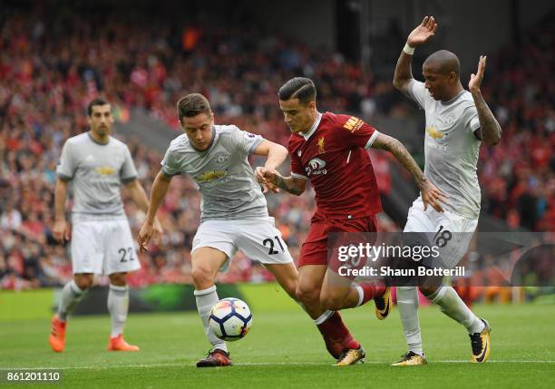 Philippe Coutinho of Liverpool battles for possession with Ander Herrera and Ashley Young of Manchester United during the Premier League match...