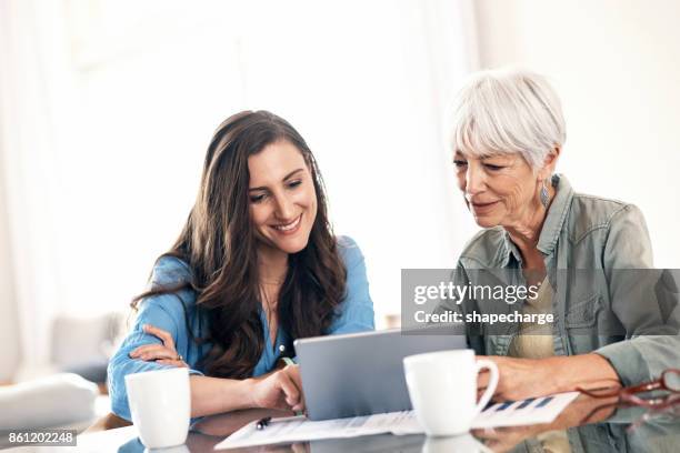 helping mom with some of her home finances - adult child stock pictures, royalty-free photos & images