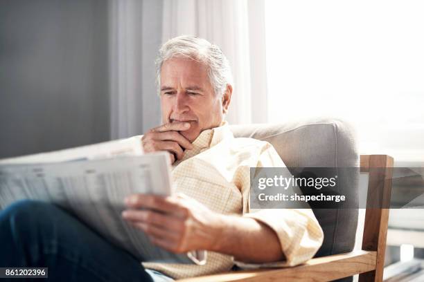 what's headlining today? - reading newspaper stock pictures, royalty-free photos & images