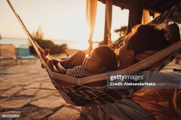 relaxing moments in a hammock - playground equipment happy parent stock pictures, royalty-free photos & images