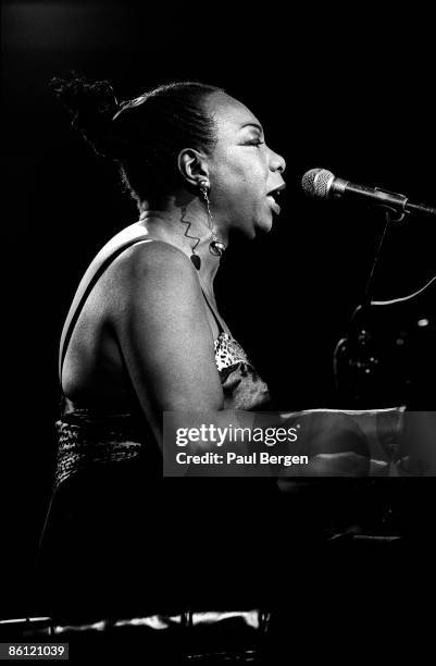 Photo of Nina SIMONE; Nina Simone performing on stage at JazzMecca in Maastricht, profile playing piano