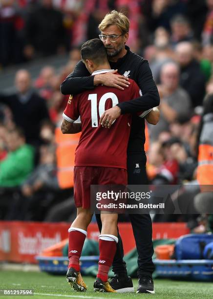 Jurgen Klopp, Manager of Liverpool embraces Philippe Coutinho during the Premier League match between Liverpool and Manchester United at Anfield on...